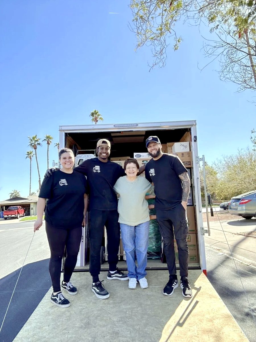 Indiana State Movers crew with a happy customer in front of a loaded trailer