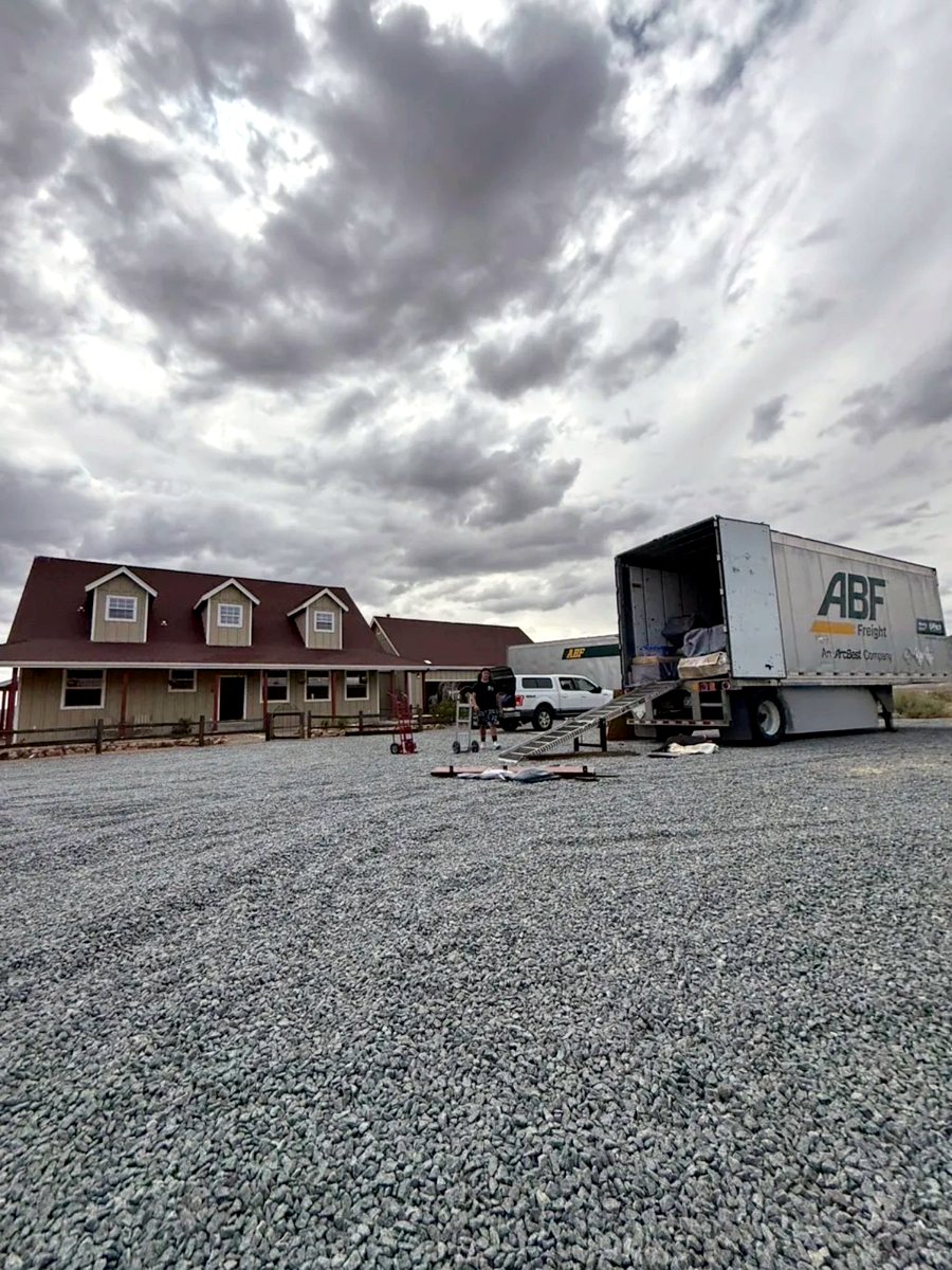 Freight trailer unloading at a rural home on a long-distance move
