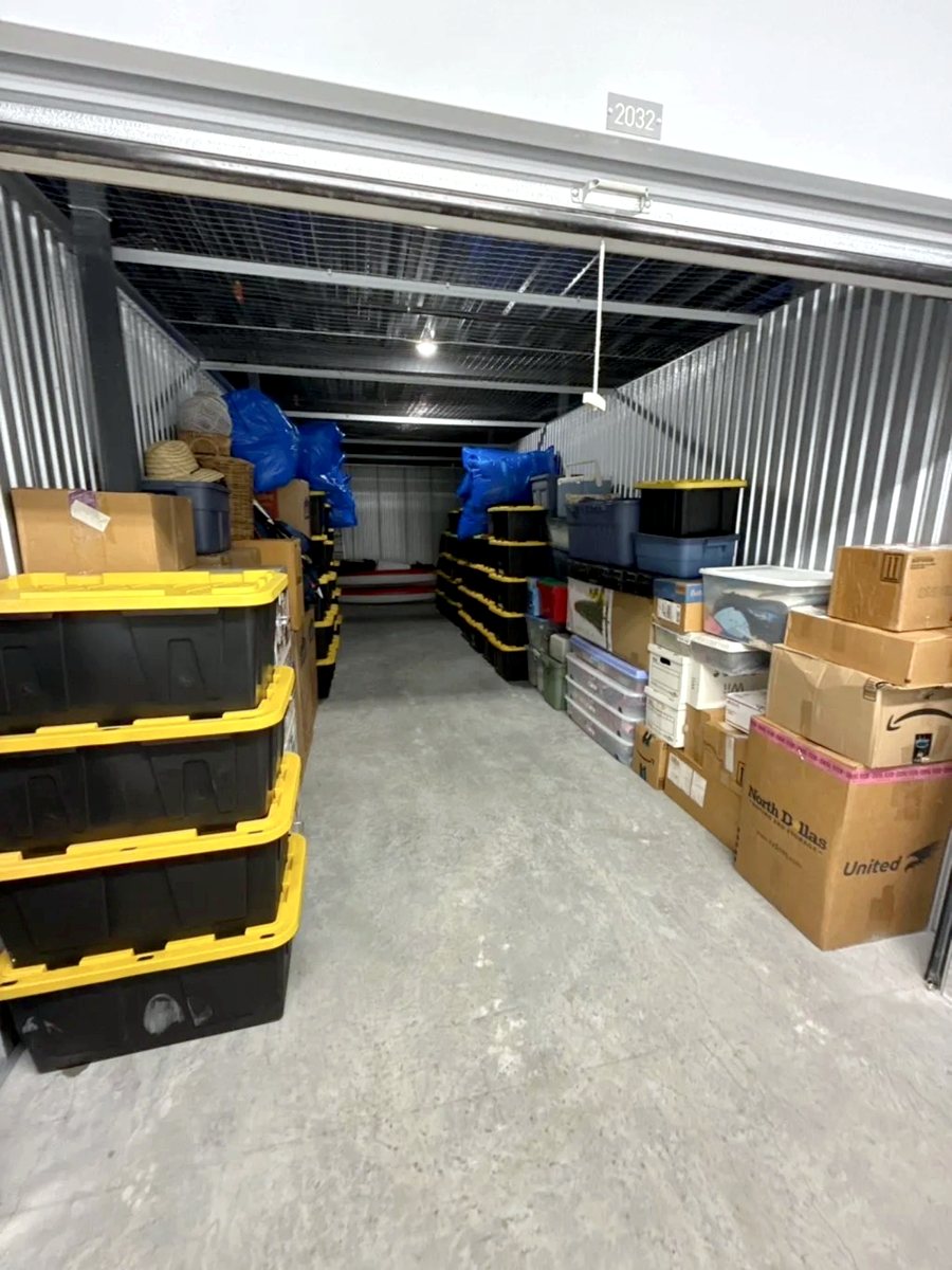 Storage unit neatly organized with stacked bins and boxes